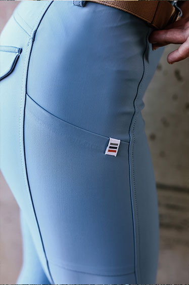 Light blue pants with a brand logo on a blurred background