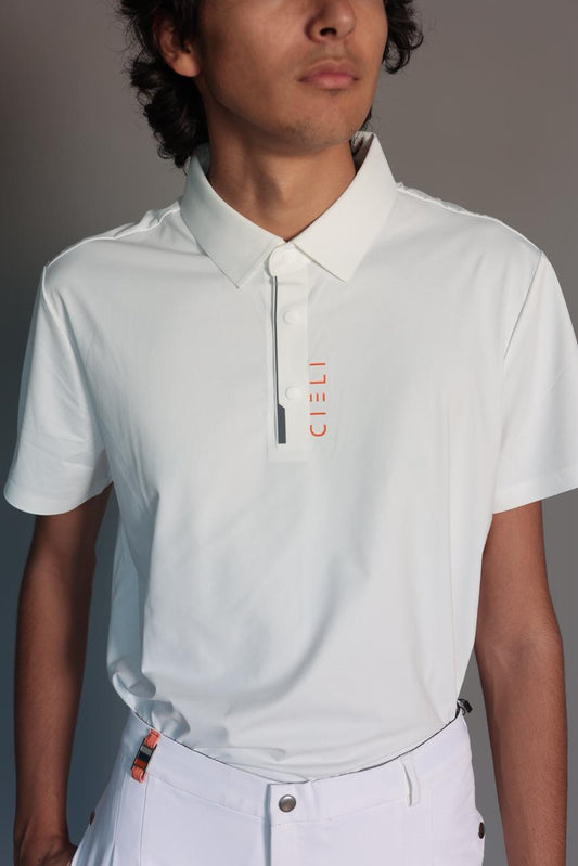 Person wearing a light gray polo shirt with a brand logo on a plain background