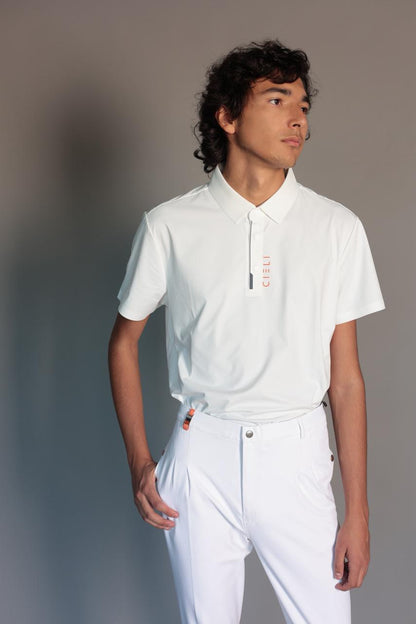Person wearing a white polo shirt and pants against a gray background