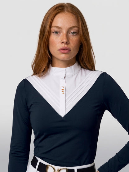 A woman wearing a navy long-sleeve athletic top with a contrasting white V-neck collar panel and gold 'CIELI' branding on the chest, paired with a white belt.