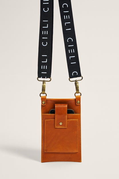 Brown leather pouch with black strap featuring 'CIELI' branding on a light gray background