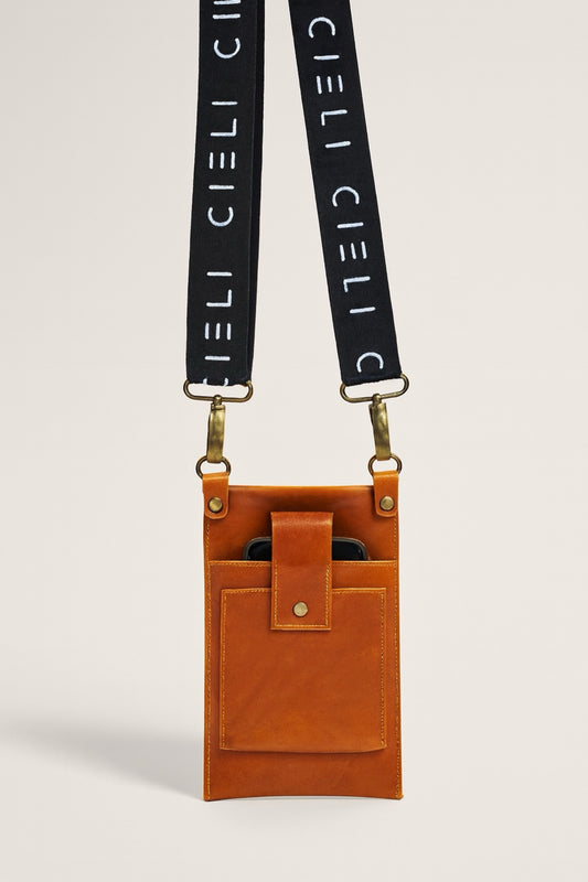 Brown leather pouch with black strap featuring 'CIELI' branding on a light gray background