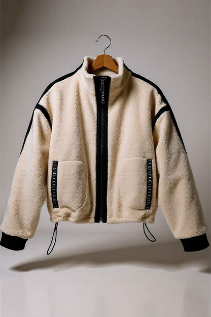 Beige fleece jacket with black accents on a hanger against a neutral background